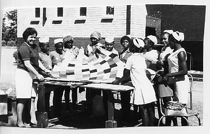 Mrs. Thetis Katsouris and Self Help African Women showing off one of their blankets presented to the Jairos Jiri Association 