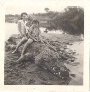 Helen Jenkinson and their two girls Leslie and Gail sitting astride an eighteen foot crocodile shot at the Umnaiti/Sinyati ju