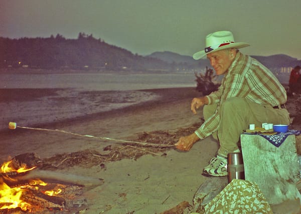 My husband, Jan toasting marshmallows on the Forth of July on Selitz Bay, Oregon