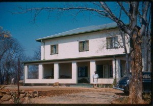 Gervas Hughes' cook Philip, who had been with the family before Tim was born, standing outside the new house on Giraffe Farm 1960